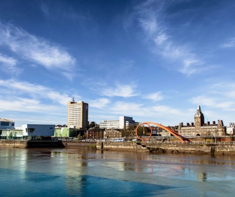 Re-Finished Newport A photo of Newport city center with the wave in the foreground